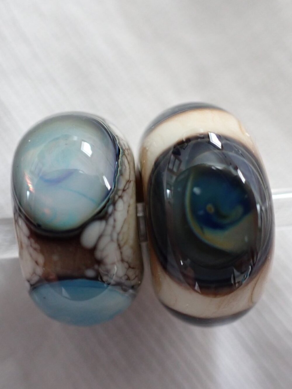 Pair of artisan glass bracelet or dreadlock beads in teal and cream colours